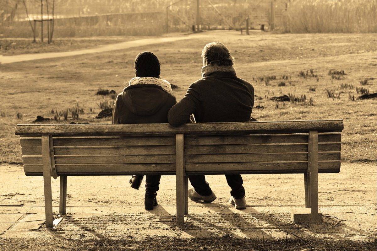 People having conversation on a bench